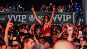 Woman on man's shoulders in concert crowd