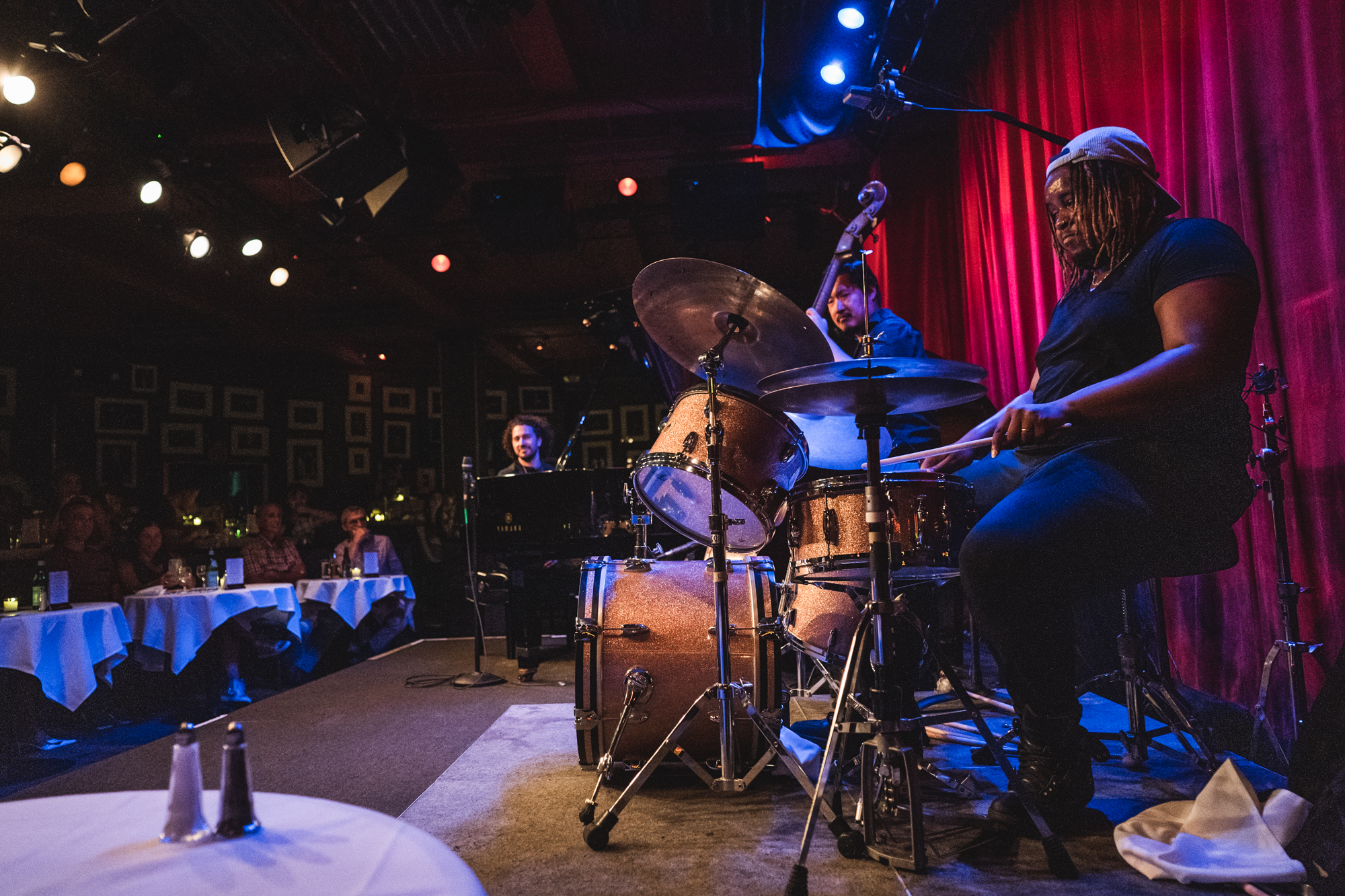 Band plays on stage at an Emmet Cohen Trio concert