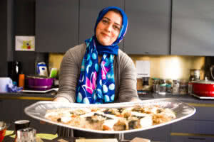 One of the Migrateful chefs presents her food