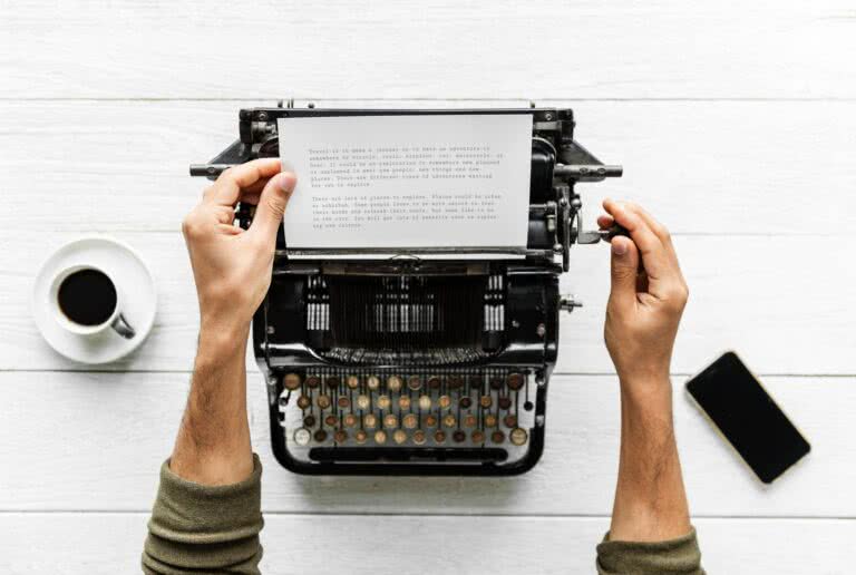 picture of a typewriter being used by someone. Perhaps brand storytelling?