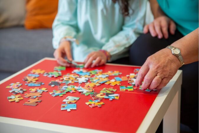 people completing jigsaw puzzles