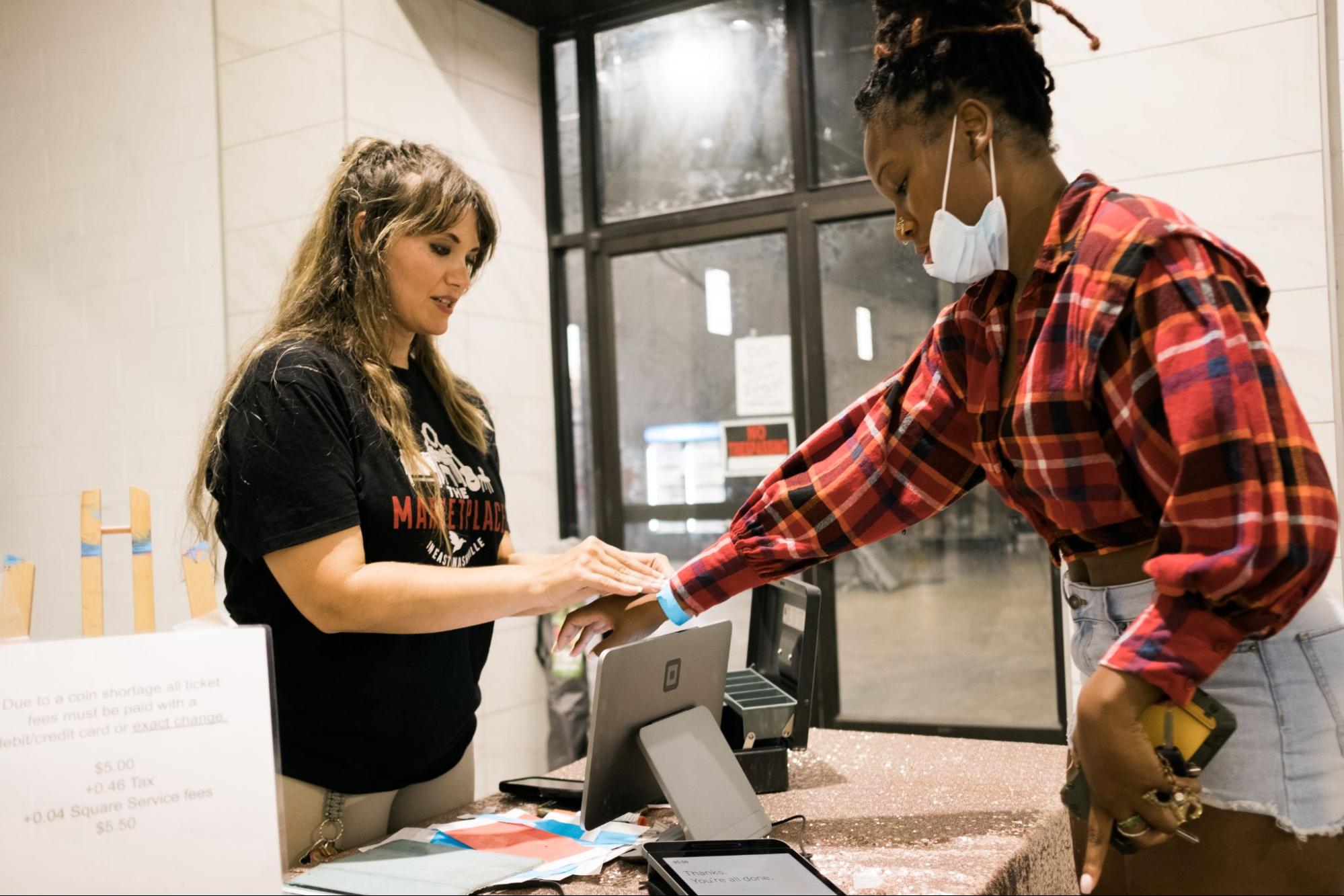 A person receiving an event wristband