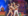 Male and female Christmas performers pose on-stage holding giant candy cane