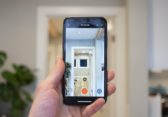 Person holds mobile phone up and prepares to record room tour