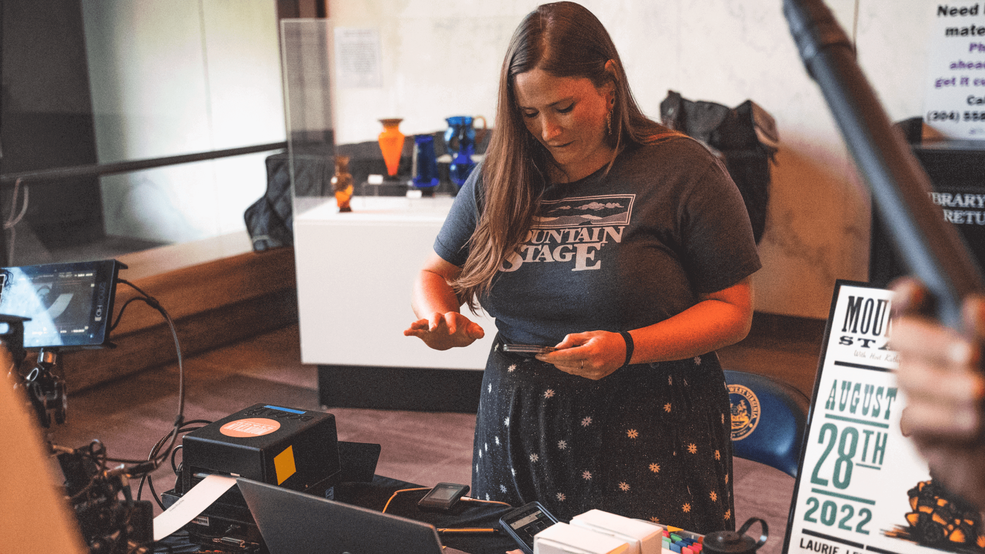 Woman using app and computer at an event