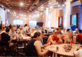 Crowd eating at tables