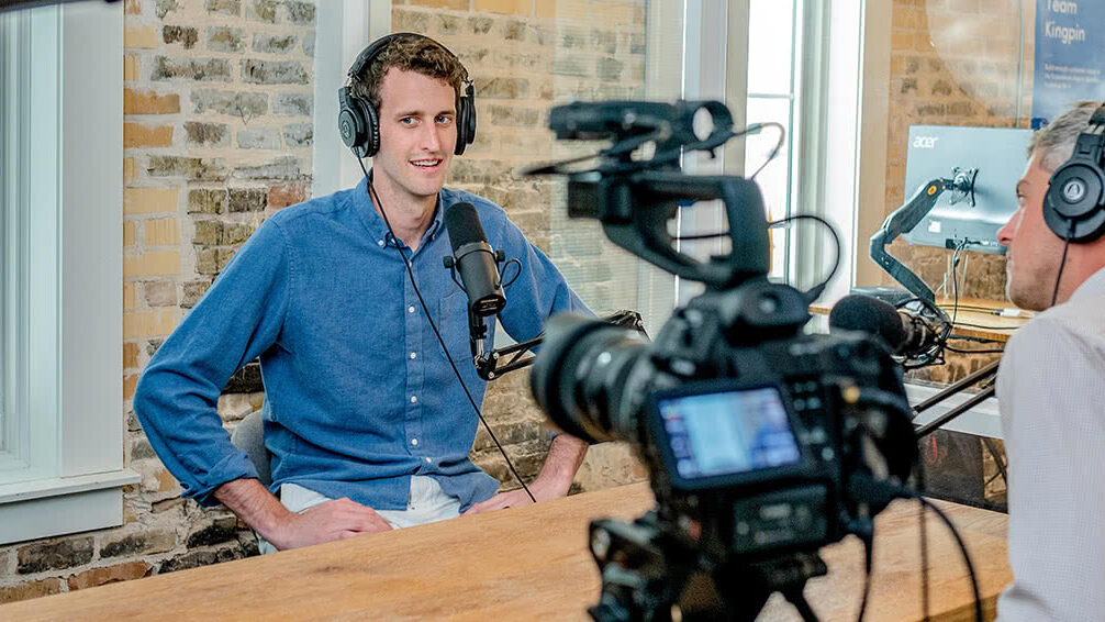 Man being filmed at a virtual event