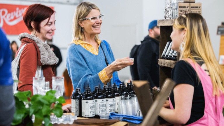 A vendor offering a sample to a customer.